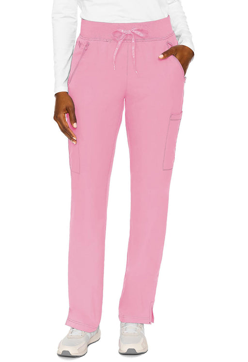 Pink pants are modeled, being displayed straight-on against a white background. A person’s hands are visible in the pockets.