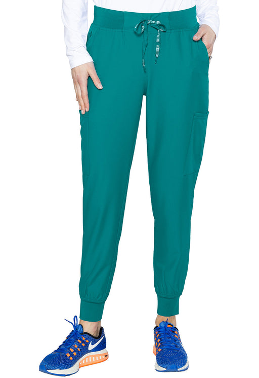 Teal jogger pants are being modeled against a white background. The pants have a drawstring waist and side pockets.