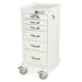 A white, multi-drawer cabinet sits on four wheels. The cabinet is tall and narrow, with several small drawers. It appears to be in a sterile or clinical setting.