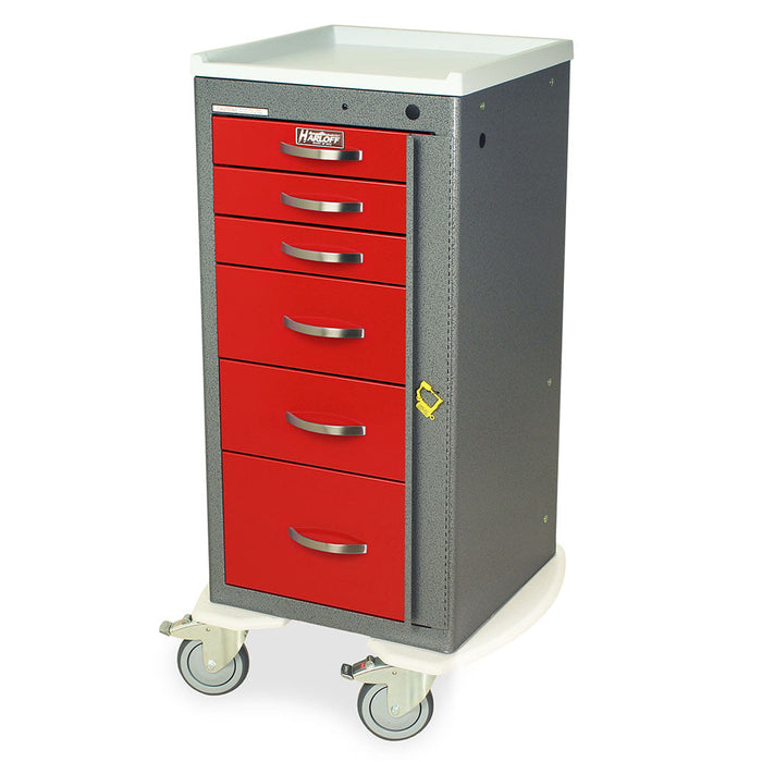 A red, multi-drawer medical cabinet sits on wheels, providing mobile storage in a clinical setting.