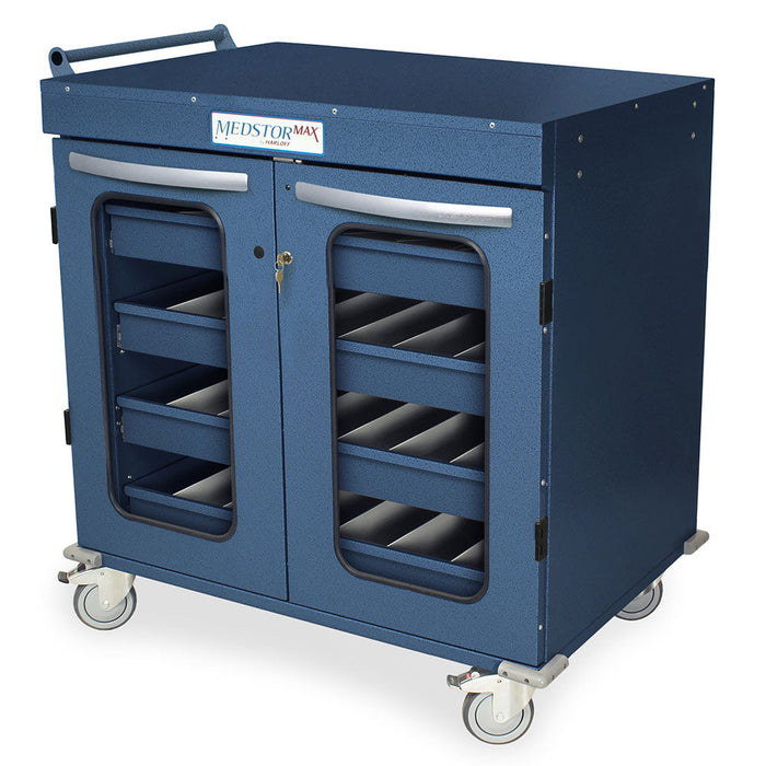 A blue MedStorMax cart sits on wheels. It features a handle, double doors with windows revealing multiple interior drawers, and a lock.