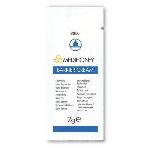 A MediHoney Barrier Cream packet displays its name and various language translations for "barrier cream," indicating its protective function. The 2g package is shown against a plain white background. #800
