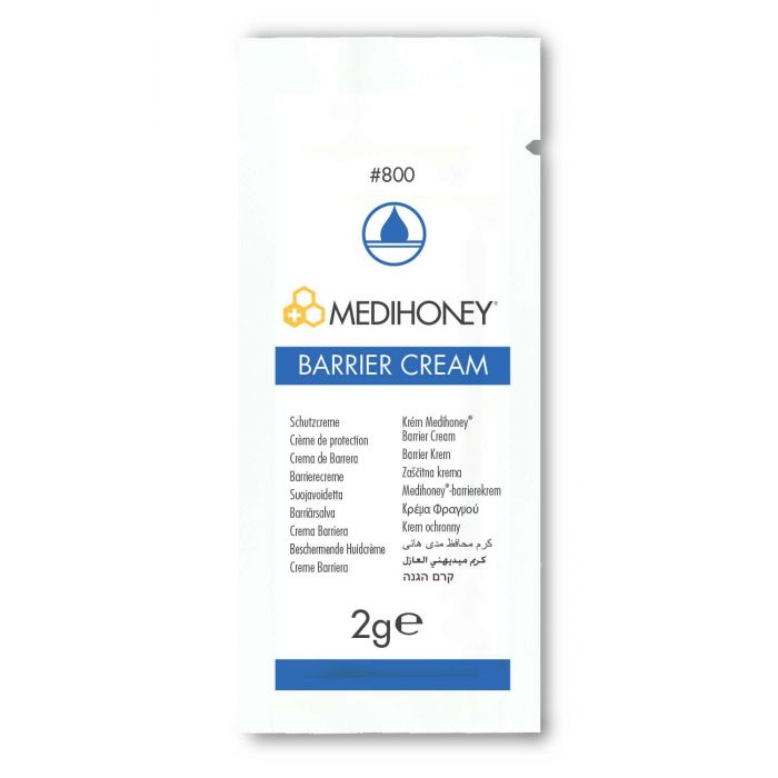 A MediHoney Barrier Cream packet displays its name and various language translations for "barrier cream," indicating its protective function. The 2g package is shown against a plain white background. #800