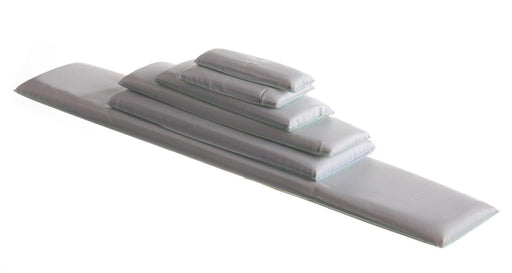 Several light-grey rectangular pads are stacked, with the largest acting as a base, on a white background.