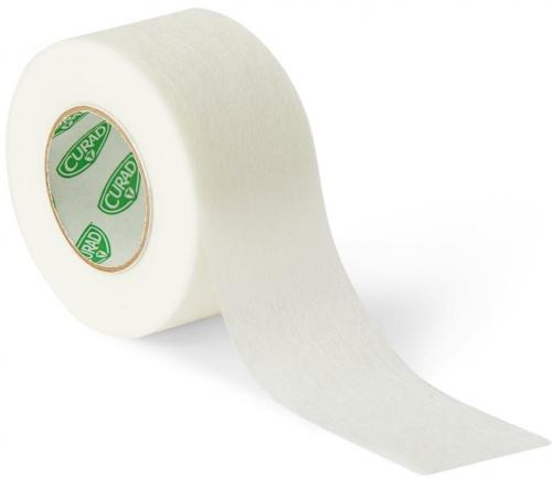 A roll of Curad medical tape unrolls on a white background. The tape is off-white, and the inner roll displays the Curad logo repeatedly.