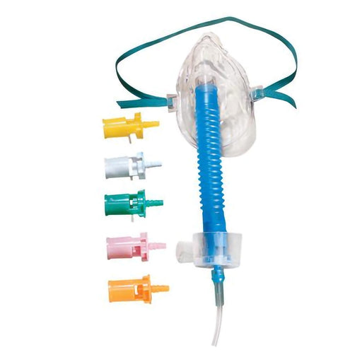 A transparent oxygen mask with a corrugated tube and adjustable head strap is shown with several colored connectors. The mask delivers oxygen. The context is a clinical or medical setting.
