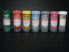 Seven small, capped vials, containing various fixatives for clinical specimens, are arranged in a row on a dark surface. Each vial is labeled with its contents and safety instructions.