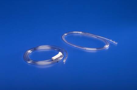 Two clear plastic tubes lie coiled on a blue surface. One tube has a small white connector. They appear to be medical devices.