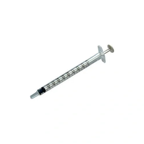A clear plastic syringe lies on a white background; it is calibrated in milliliters.