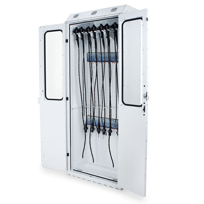 A white cabinet stores multiple long, black tubes hanging vertically, likely for medical equipment. The cabinet doors are open, revealing the contents within.