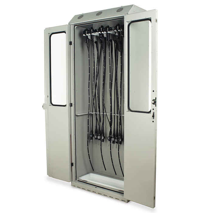 A metal cabinet stores numerous long, black, flexible medical tubes hanging from a rack inside; its double doors are open, revealing its contents in a clean, sterile environment.