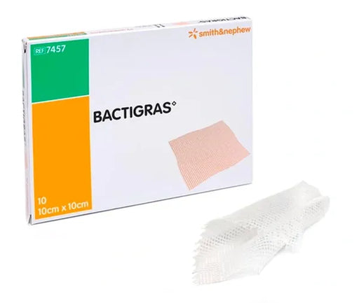 A BACTIGRAS® gauze pad, shown in its box and unfolded, rests on a white surface. The box shows the brand name and dimensions: 10cm x 10cm, REF 7457. Smith & Nephew is also indicated on the box.