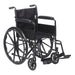A black wheelchair sits on a white background. It has large wheels and armrests.