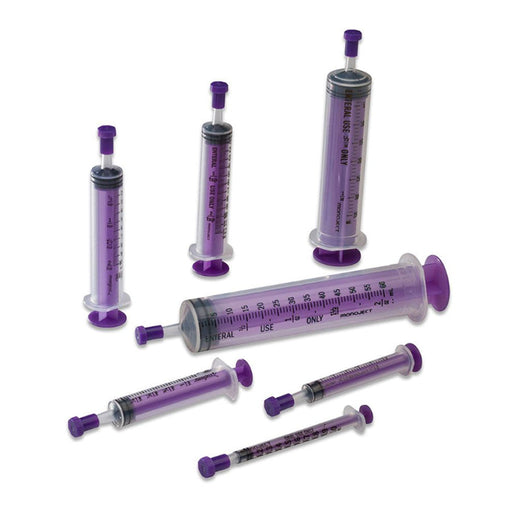 Several clear, plastic, purple-tinted syringes of different sizes are arranged on a white surface. They are labeled “ENTERAL USE ONLY” with a purple plunger.