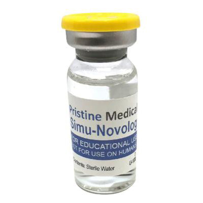 A small, clear glass vial containing a liquid sits on a surface. It has a yellow cap and a label that reads, “Pristine Medical Simu-Novolog FOR EDUCATIONAL USE, NOT FOR USE ON HUMANS. Contents: Sterile Water.”