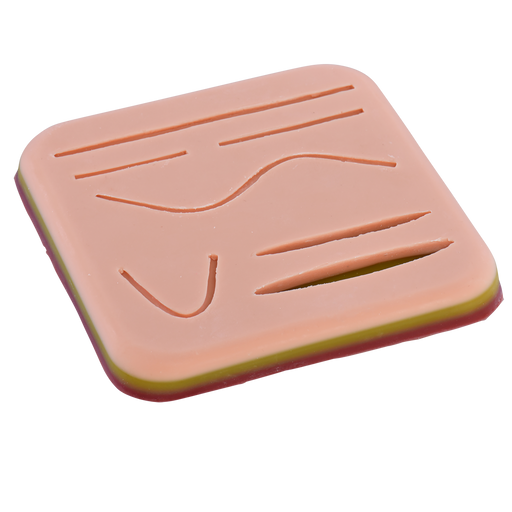 A pale pink, layered practice skin displays various incised lines and curves for suture training.