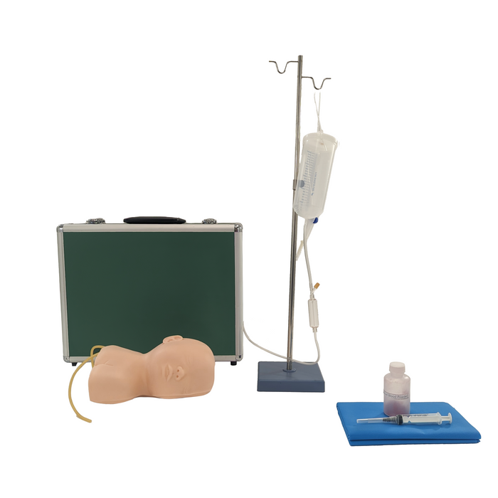 A medical training torso model lies near a briefcase, next to an IV pole with a bag and tubing, and a syringe and vial on a blue cloth.