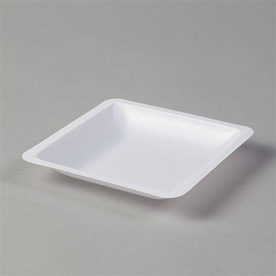 A white, square-shaped, shallow dish sits on a gray surface.