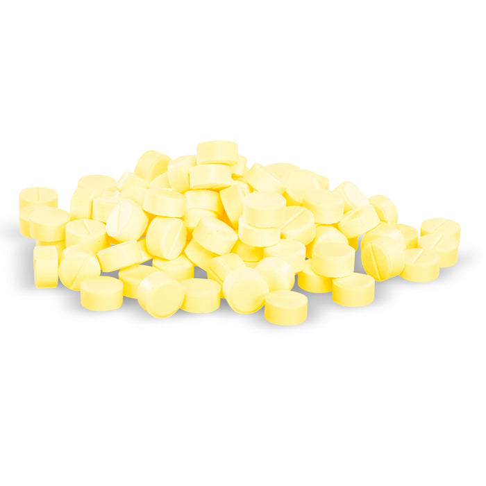 A pile of pale yellow pills sits on a white background.