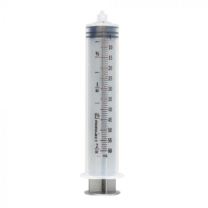 A clear plastic monoject syringe, calibrated in milliliters and ounces, stands upright against a white background.