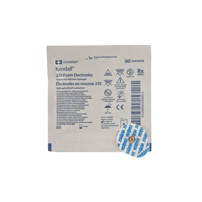 A single-use Kendall 235 foam electrode, with conductive adhesive hydrogel, sits attached to its packaging.