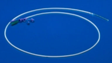 A translucent, thin catheter lies coiled on a solid blue background. A small, multicolored connector is visible at one end.