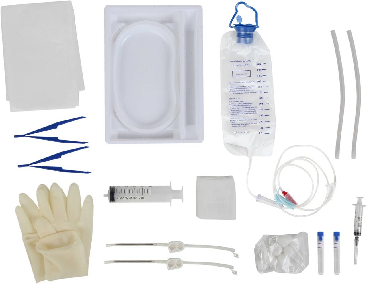 A medical kit containing various instruments and supplies is displayed. The items include tweezers, gloves, syringes, tubing, a feeding bag, and other sterile materials. The bag is labeled "Enteral Feeding Bag Kit".