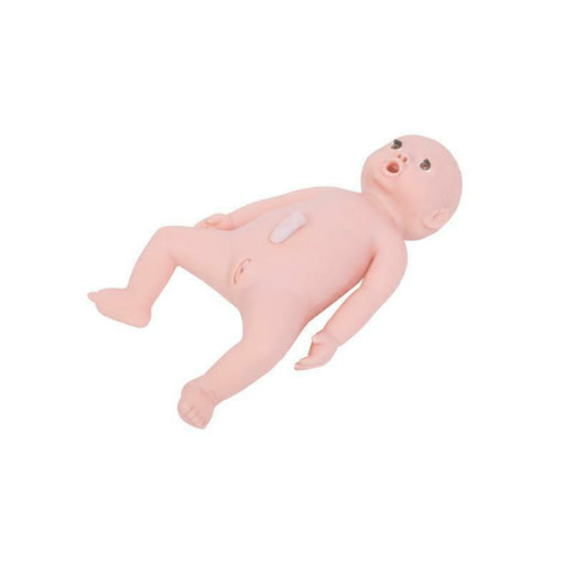 A realistic baby doll lies supine on a white background. The doll's mouth is open. A small, pale, rectangular object is affixed to its abdomen.