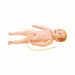 A baby doll lies on its back. A thin yellow tube wraps around the doll’s midsection on a white background.