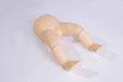 A baby doll torso and legs lie on a white surface.