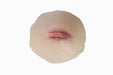 A simulated wound, appearing as a small laceration, is affixed to a pale, flesh-toned prosthetic.