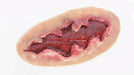 A simulated laceration, exhibiting a deep, irregular tear with exposed red tissue, rests on a plain white background.