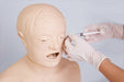 A medical dummy is being injected near the eye by hands wearing white surgical gloves, possibly in a training scenario, against a solid background.