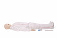 A medical dummy lies supine on a white surface. It is clothed in white surgical scrubs and wearing white sneakers. Next to it lies a box of “KY jelly”.