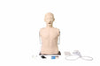 A CPR manikin sits upright; accessories, like a bag-valve mask, lie nearby. The manikin is light-skinned and has an open mouth in front of a white background.