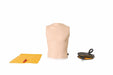 A CPR training manikin torso stands alongside a yellow pad and black bag on a stark white surface.