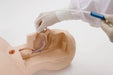 Gloved hands insert a clear tube into the throat of a light-skinned medical mannequin against a stark white background.