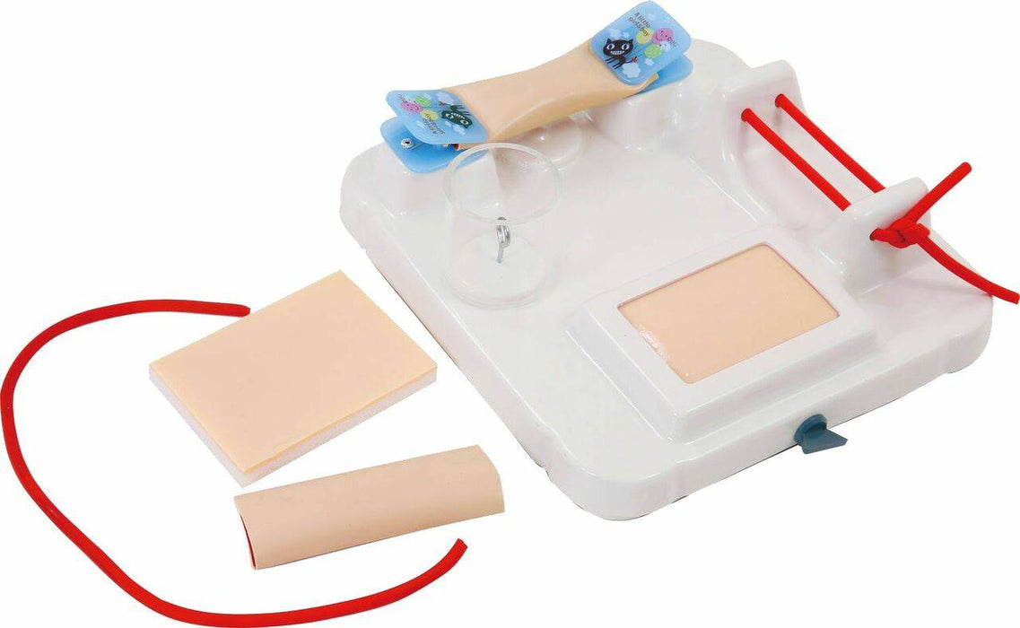 A medical simulation kit; it shows a practice model with attached components and separate practice skin pieces for demonstration.
