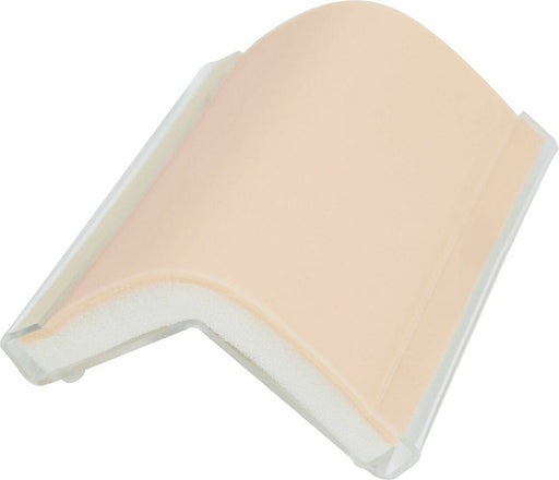 A flexible, skin-toned practice pad rests on a clear plastic frame. The pad is curved, suggesting use for practicing injection or incision techniques.