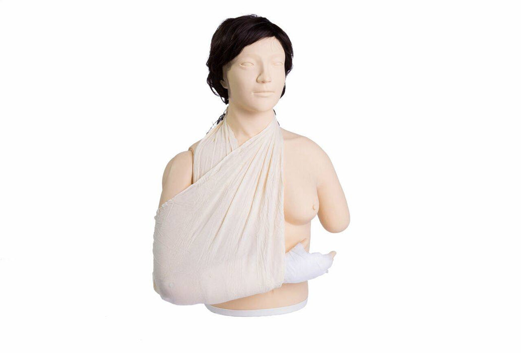A mannequin with dark hair is shown wearing a sling on its left arm, standing in a bright, white space.