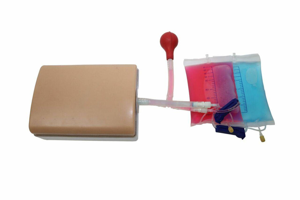 A mannequin's midsection is connected via tubing to a red bulb and two bags, one with pink liquid and one with blue liquid. The bags feature clear volume measurements.