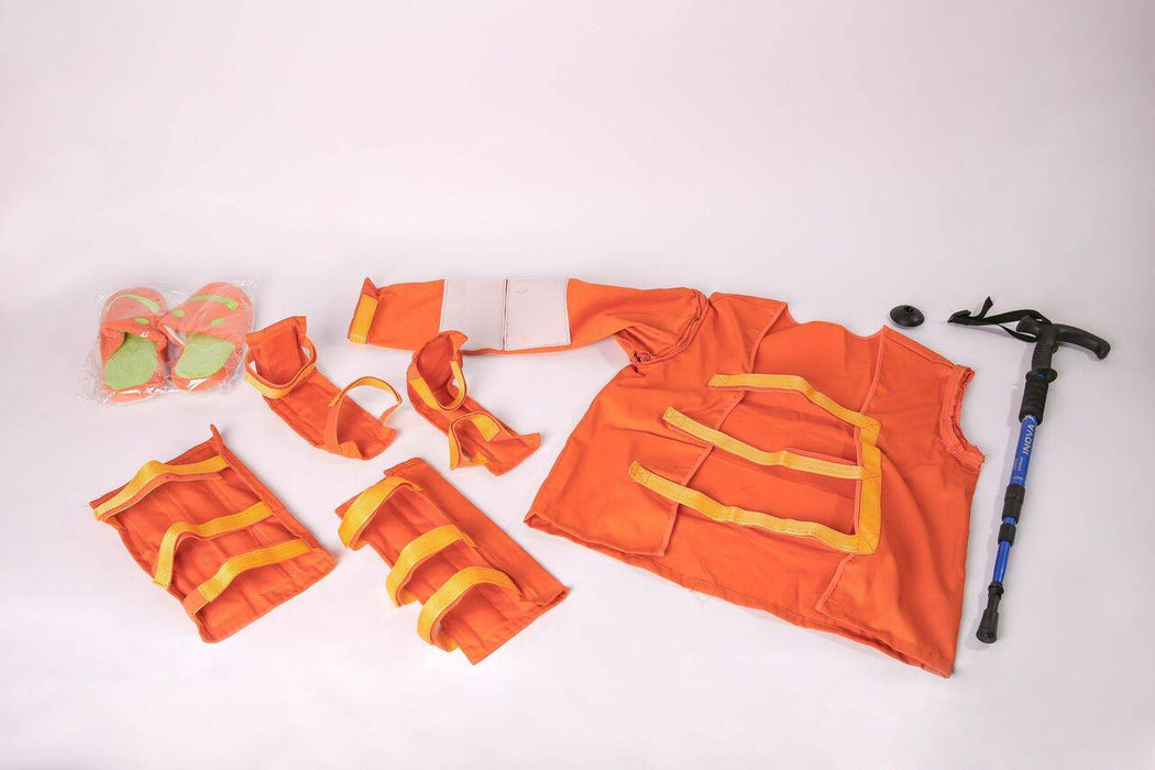 An orange rescue kit sits, spread apart on a white background, with an ice ax lying to the right.