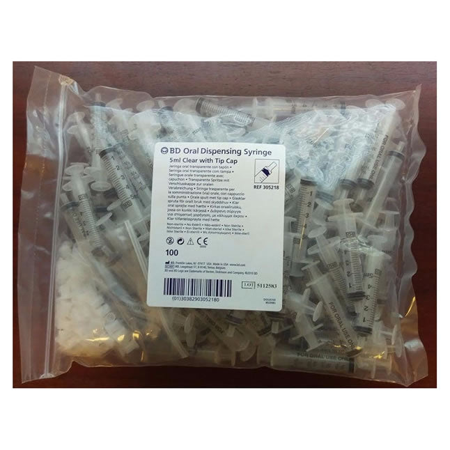 A bag of one hundred 5ml oral dispensing syringes, with tip caps, are contained within a plastic bag.