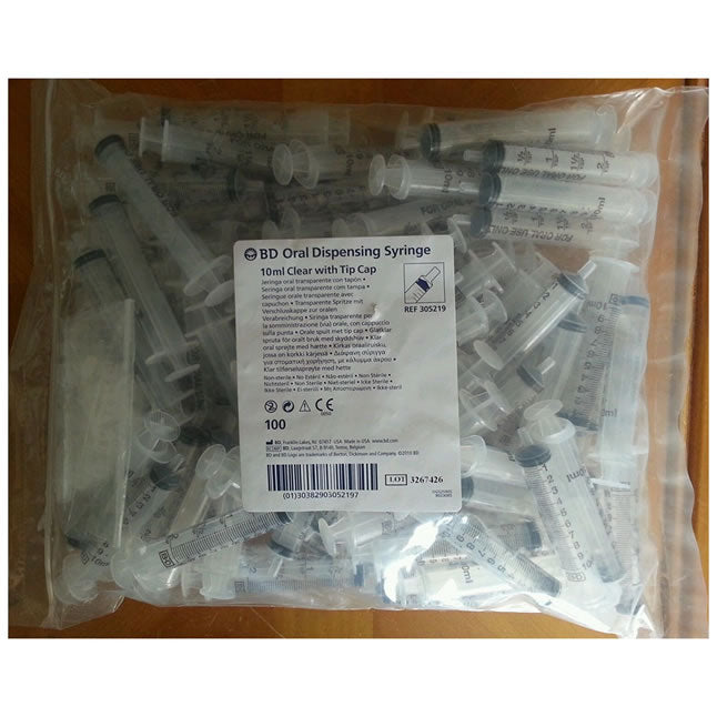 One hundred 10ml oral syringes with tip caps are contained within a clear plastic bag. The syringes are clear plastic. The bag is sealed.
