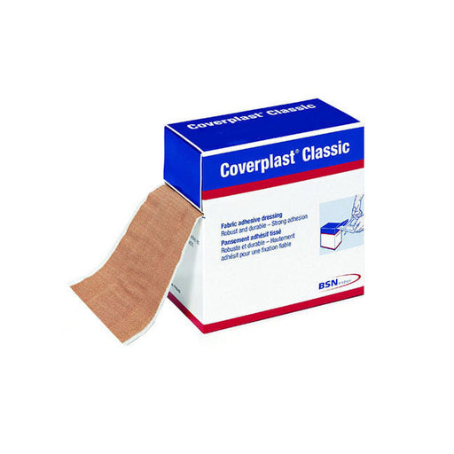 A tan fabric adhesive bandage is emerging from its box; the box is blue and white, labeled "Coverplast Classic," indicating its contents and brand.