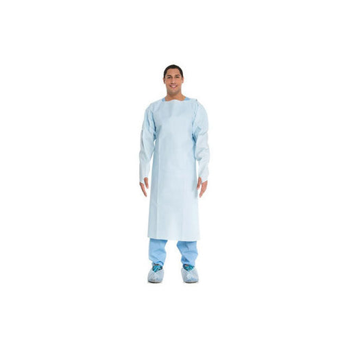 Man stands facing forward, wearing a light blue medical gown, pants, and shoe coverings, set against a white background.