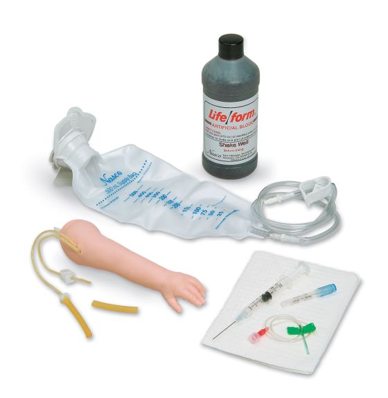 A training arm model rests near an IV bag and tubing, along with a bottle of liquid and a needle insertion pad, simulating an intravenous injection setup for practice.