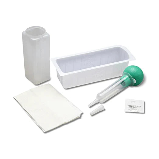 A medical kit containing a syringe, a small container, and other supplies rests on a white background.
