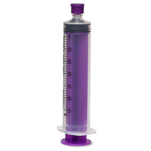 A large, purple, plastic syringe with measurements from 5-35 mL stands upright. It is positioned on a white surface.