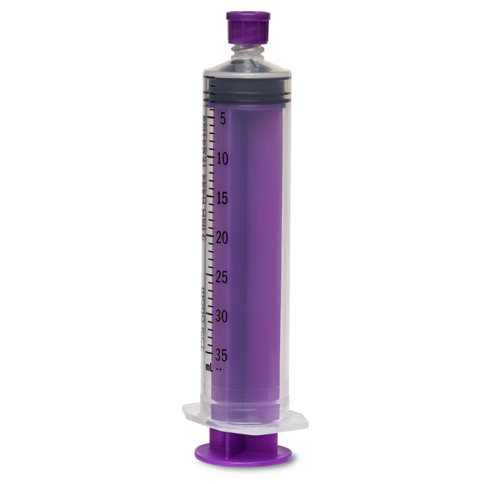 A large, purple, plastic syringe with measurements from 5-35 mL stands upright. It is positioned on a white surface.
